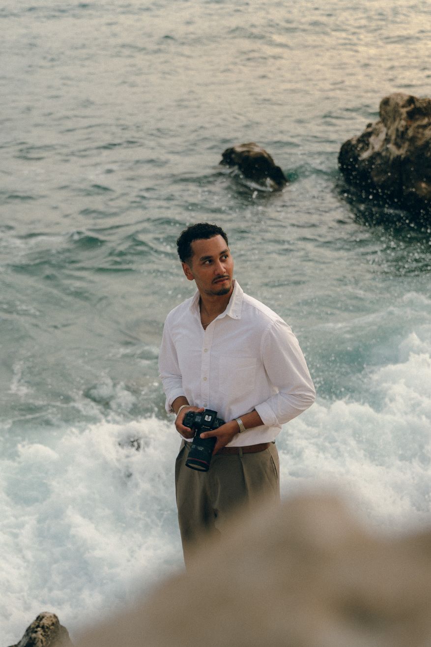 Kassim the photographer holding a camera covering one eye